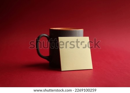Blank adhesive note paper with gray coffee cup on red background
