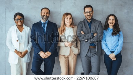 Portrait of multi-ethnic male and female professionals. Business colleagues are standing against wall. They are in formals at office. Confident individuals make a confident team. Royalty-Free Stock Photo #2269100687