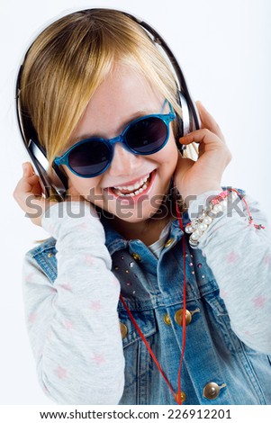 Portrait of beautiful child listening to music with digital tablet.