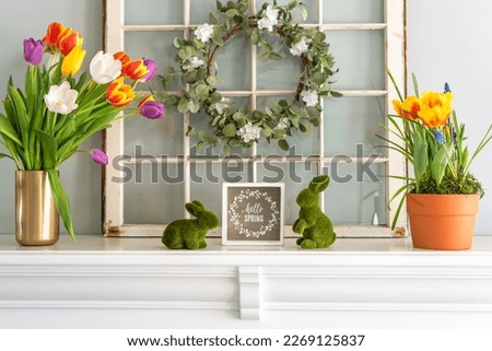 White mantel decorated for Spring with tulips and bunnies Royalty-Free Stock Photo #2269125837