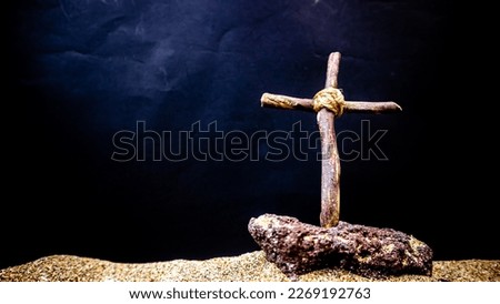 wooden cross on black background