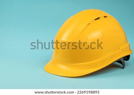 Construction helmet yellow on a blue background. Construction concept Royalty-Free Stock Photo #2269198893