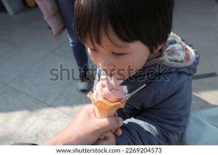 Baby eating ice cream image.