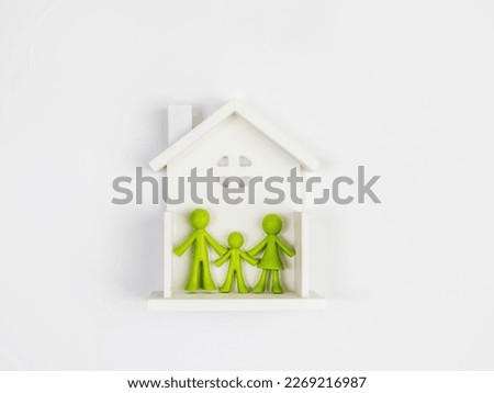 The figurines of the little people in the house. The concept of a family
