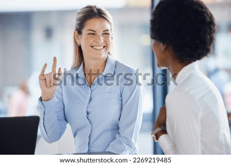 Collaboration, meeting and hand gesture with business women in the office, working on a project together. Teamwork, planning or shaka sign with a happy female employee and colleague talking at work