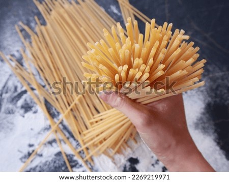 First person shoot of bucatini pasta. ingredients of typical italian cuisine. Royalty-Free Stock Photo #2269219971