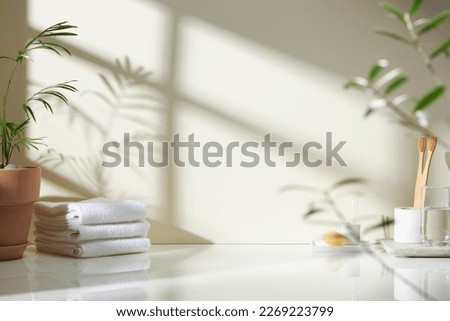 Various objects on a white tile background with warm sunlight shining through
 Royalty-Free Stock Photo #2269223799