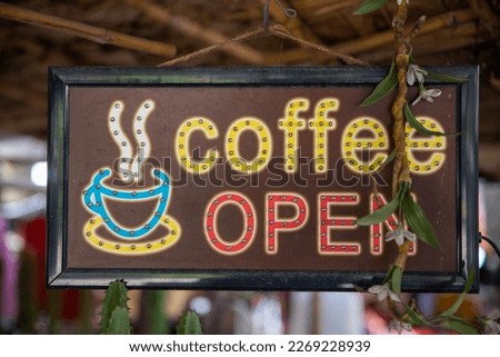 Open Coffee Shop Sign. Wooden sign board hanging on door of cafe