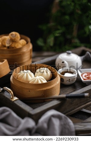 Dim sum, pao, sosis roll in bamboo basket
 Royalty-Free Stock Photo #2269230933