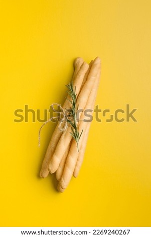 Italian grissini bread sticks on the yellow background. Top view. Royalty-Free Stock Photo #2269240267