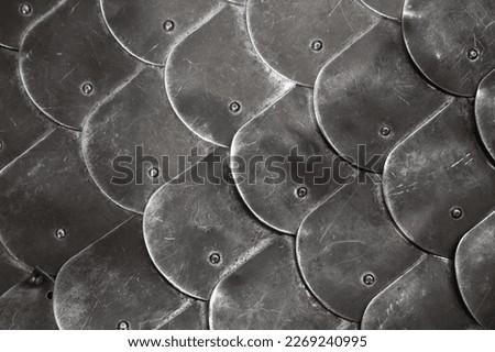 Scale body armour made of steel plates. Medieval knight armor close up photo with selective soft focus Royalty-Free Stock Photo #2269240995