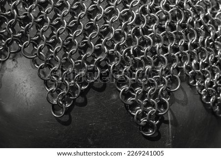 Medieval knight torso armor close up photo with selective soft focus. Chain mail made of linked steel rings lays over steel torso armor Royalty-Free Stock Photo #2269241005
