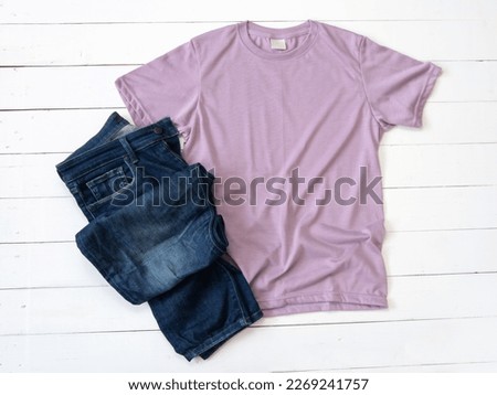 Purple T Shirt mockup and Jeans on white wood background shirt template