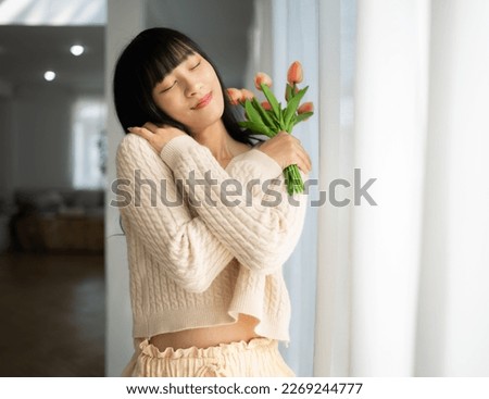 Embrace equity on multiracial Internal Women's Day. Asian lady good mood hands hug herself shoulders enjoy joyful warmth toothy smile. Royalty-Free Stock Photo #2269244777