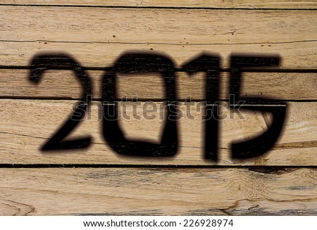 2015 Happy New Year greeting cards, wood burning wood background.