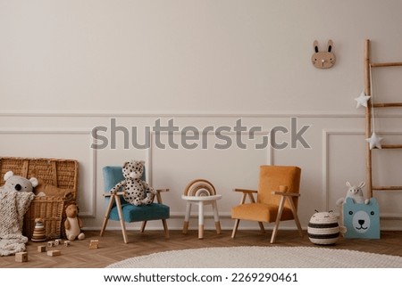 Warm and cozy kids room interior with orange and beige armchair, white stool, round rug, plush toys, wooden blockers, beige wall with stucco, ladder and personal accessories. Home decor. Template.