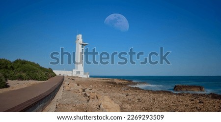 Moon over the white lighthouse 