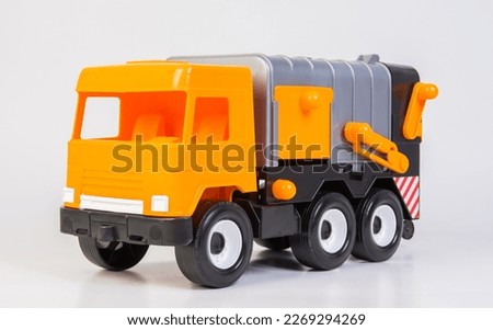 Garbage truck. Multi-colored children's toys plastic trucks on a white background.