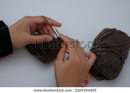 Crochet handmade for amigurumi pattern, crocheting supplies, assorted colored wool yarn, hook, knitting crocheting. Selective focus