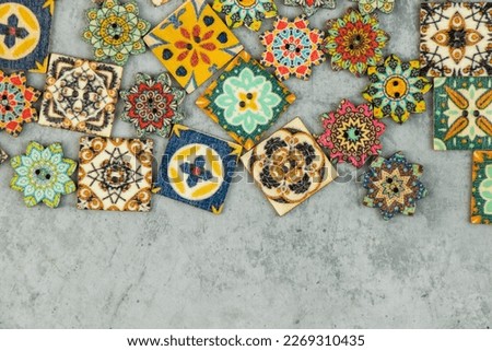 Colorful ornamental button on the gray background, backdrop