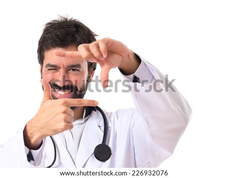 Doctor focusing with his fingers on a white background
