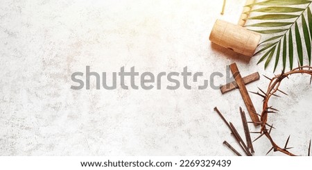 Crown of thorns, wooden cross, nails and mallet on light background with space for text. Good Friday concept