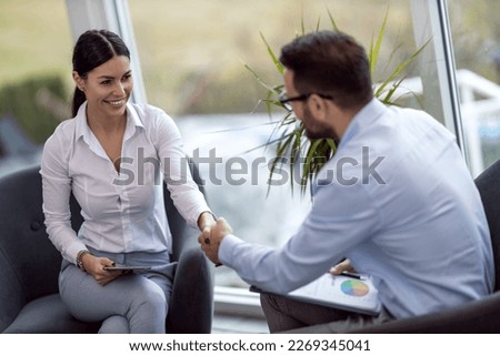 Real estate agent with woman closing a deal.Happy young woman moving in new house. Royalty-Free Stock Photo #2269345041