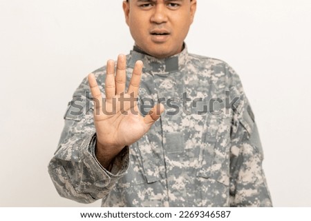 Don't sign stop war. Asian man special forces soldier standing with Stop the war stop the violence. Commander Army soldier military defender of the nation in uniform standing on white background.