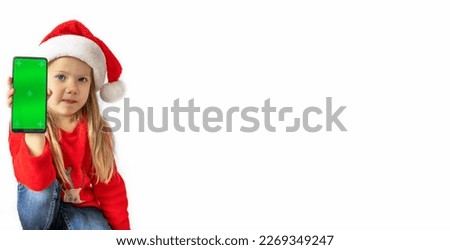 Christmas.Girl in santa hat holding green screen phone, copy space, isolate. Concept poster, text, banner, invitation, template, vacation, holiday, advertising,promotion,card, gift, action,mockup.