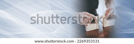 Hands building a wooden block bridge; concept of business association; panoramic banner Royalty-Free Stock Photo #2269353131