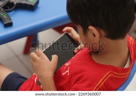 Child boy play game smartphone