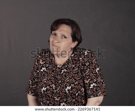 Fifty-something woman having throat and neck pain. High-quality photo showing a woman in physical discomfort.