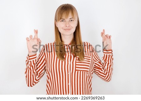 Woman Crossing Fingers in Hopeful Gesture