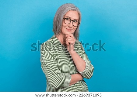 Photo of dreamy smart mature woman advisor wear green shirt spectacles arm chin isolated blue color background