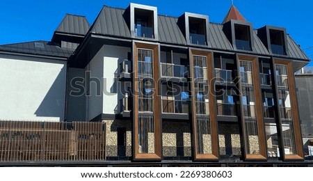 contrasting three-story building made of different modern materials, with an attic floor, modern architecture Royalty-Free Stock Photo #2269380603