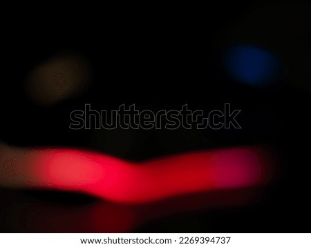 Blurred orange light lines for an abstract dark toned background.