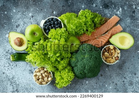 Ketogenic diet concept. A set of products of the low carb keto diet. Green vegetables, nuts, fish salmon, vegetables, nuts, berries. Healthy food concept. Keto diet food Royalty-Free Stock Photo #2269400129