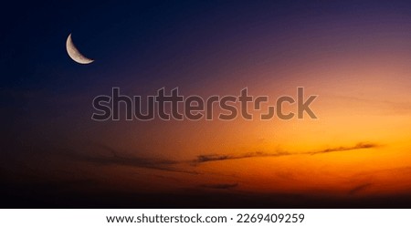 Dusk, Sky twilight in the Evening with sunset orange sunlight and Crescent moon free space for religion Islamic text Ramadan, Eid Al Adha, Eid Al Fitr, Eid Mubarak 