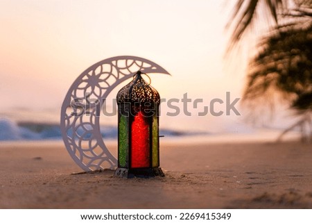 Eid Mubarak Lantern with crescent moon on the beach Royalty-Free Stock Photo #2269415349