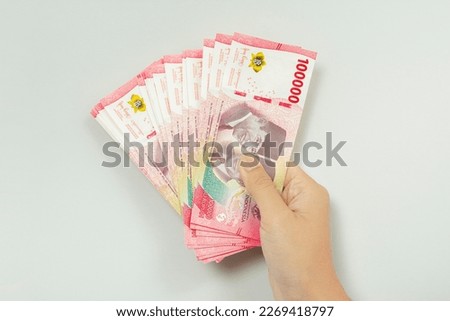 Cash payment concept. Indonesian rupiah currency (Rp. 100.000 Seratus Ribu Rupiah), One hundred thousand Indonesian rupiah money. Royalty-Free Stock Photo #2269418797