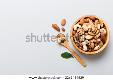 mixed nuts in bowl. Mix of various nuts on colored background. pistachios, cashews, walnuts, hazelnuts, peanuts and brazil nuts. Royalty-Free Stock Photo #2269434639