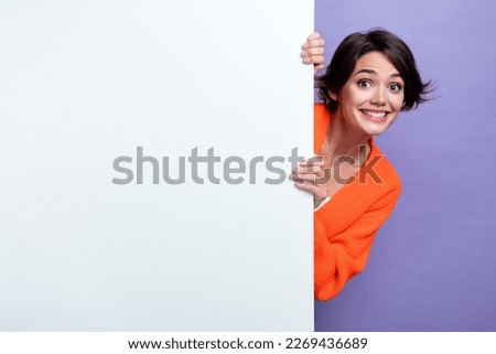 Photo of optimistic funky girl bob brunette hairstyle hide paper whiteboard empty space presentation cheap price isolated on violet color background