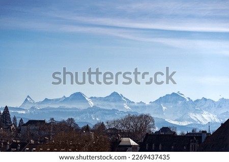 Scenic view of skyline at City of Bern with famous peaks Eiger, Monk and Virgin in the background on a sunny winter day. Photo taken February 21st, 2023, Bern, Switzerland.