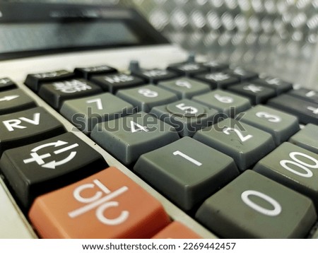Calculator and background blur of office equipment