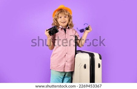 Child with travel suitcase on vacation. Kids travel and adventure concept.