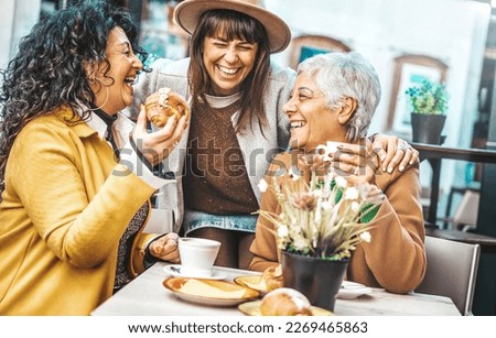 Three senior women enjoying breakfast drinking coffee at bar cafeteria - Life style concept with mature female having fun hanging out on city street  Royalty-Free Stock Photo #2269465863