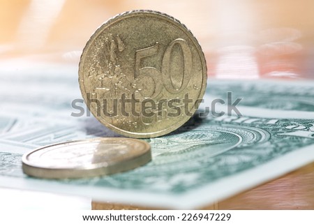 Euro coins on a background of dollars