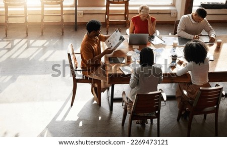 Planning, teamwork people and startup meeting of creative strategy, digital project management and design ideas. Productivity, brainstorming and business or office team working on portfolio on top Royalty-Free Stock Photo #2269473121