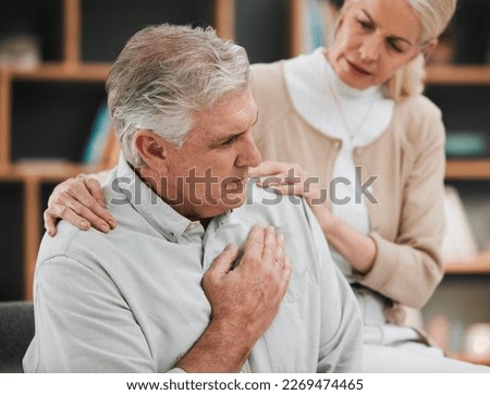 Heart attack, pain and senior couple at home with cardiology problem or stroke. House, cardiac arrest and retirement of a man with emergency and health issue in a living room with female support Royalty-Free Stock Photo #2269474465