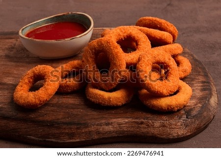 crispy chicken rings, fried, on a wooden board, close-up,